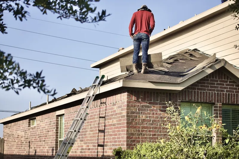 Professional roofer working on a residential roof in Pikeland